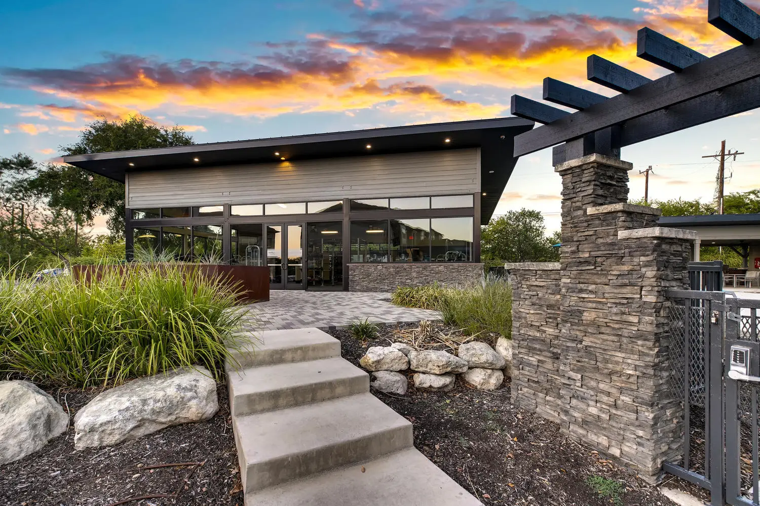 walkway to outdoor amenities with gates and natural landscaping