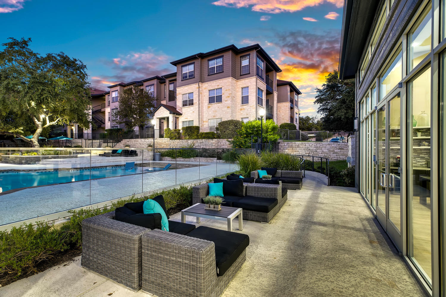 Lounge area near pool with pillows and tables