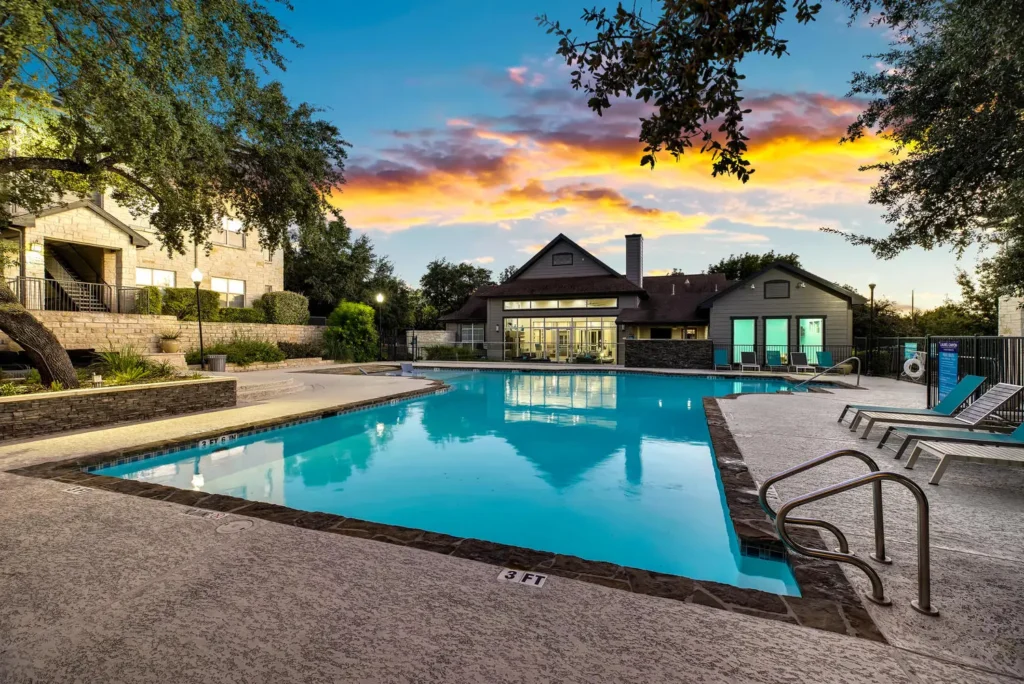 Swimming pool with lounge seating at Laurel Canyon, gated apartments in San Antonio, TX