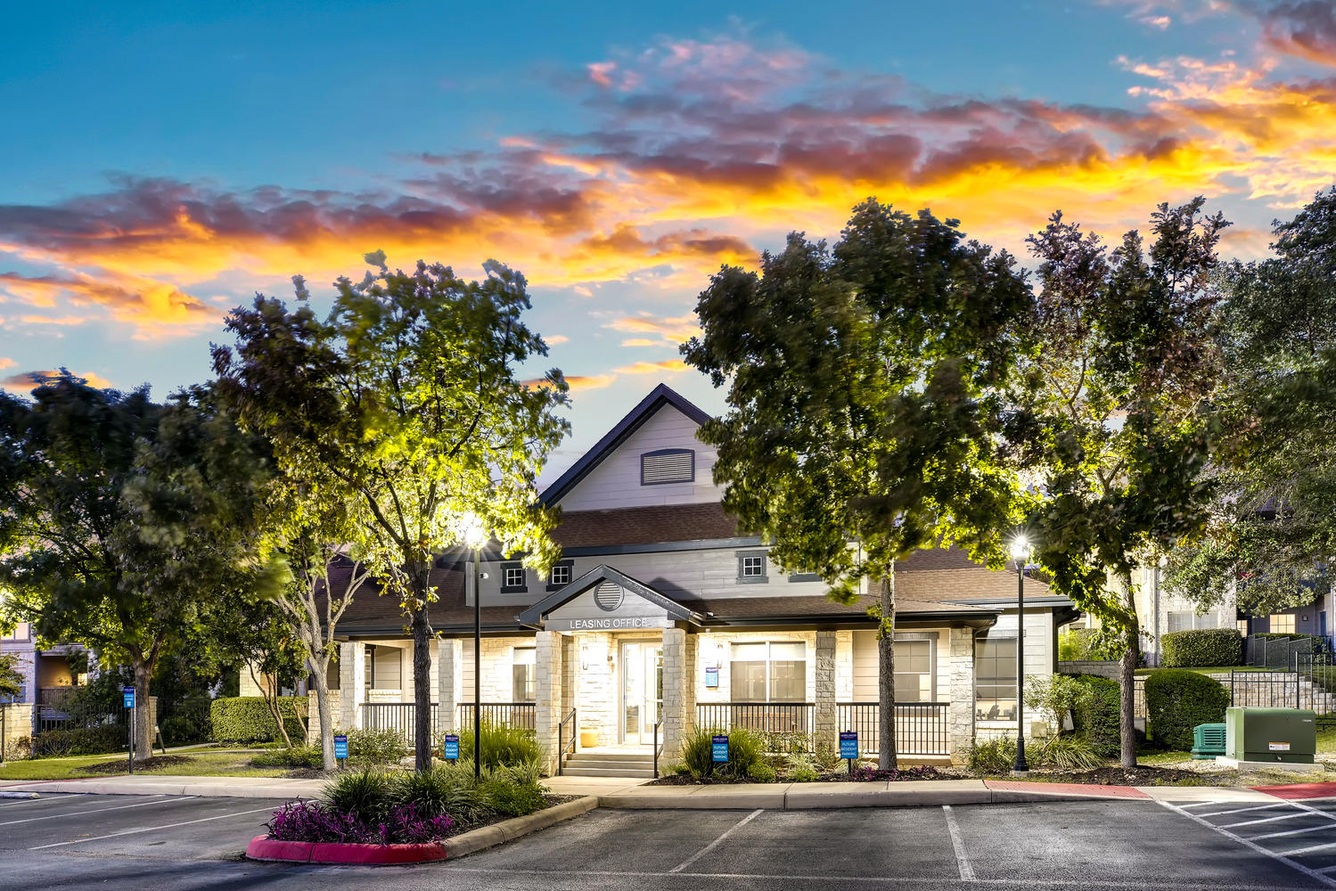 Leasing center in the evening with trees and lights