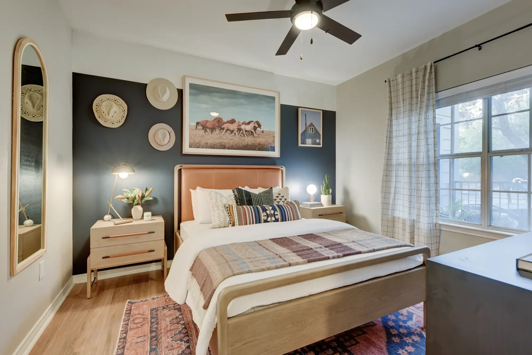 Bedroom with wood-style flooring, window, and ceiling fan