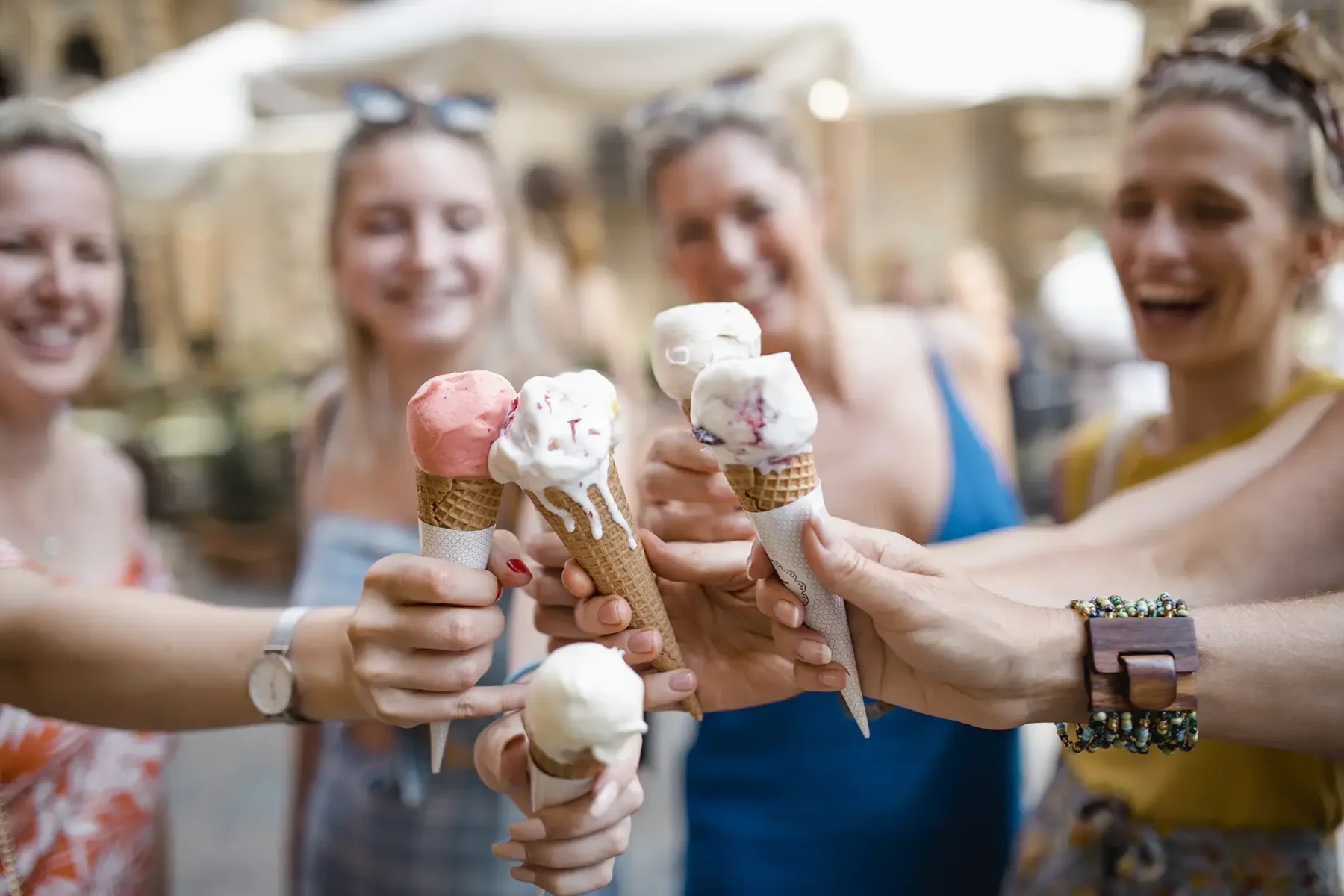 friends holding ice cream cones and enjoying the neighborhood