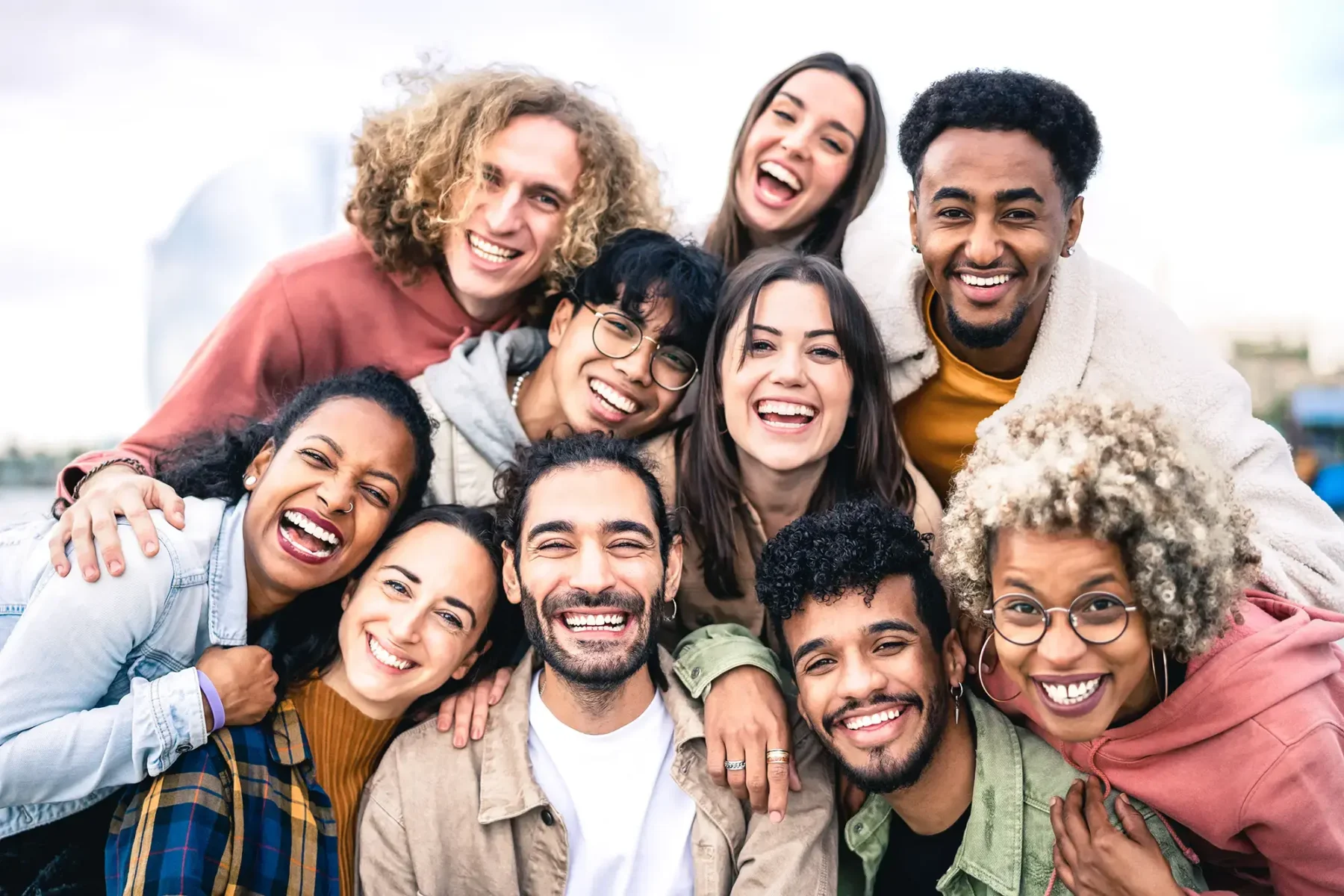 group of friends smiling, laughing, and posing for photo